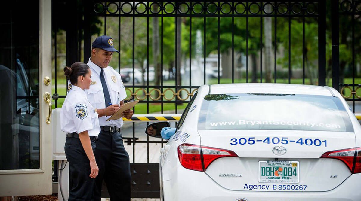 bryant security guards helping visitor at front gates of private residential community