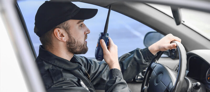 bryant-security-patrol-officer-in-mobile-patrol-car-communicating-through-radio