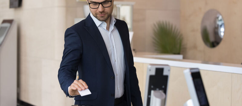man-in-a-business-suit-using-key-card-at-an-entrance-lobby-to-a-commercial-business-building